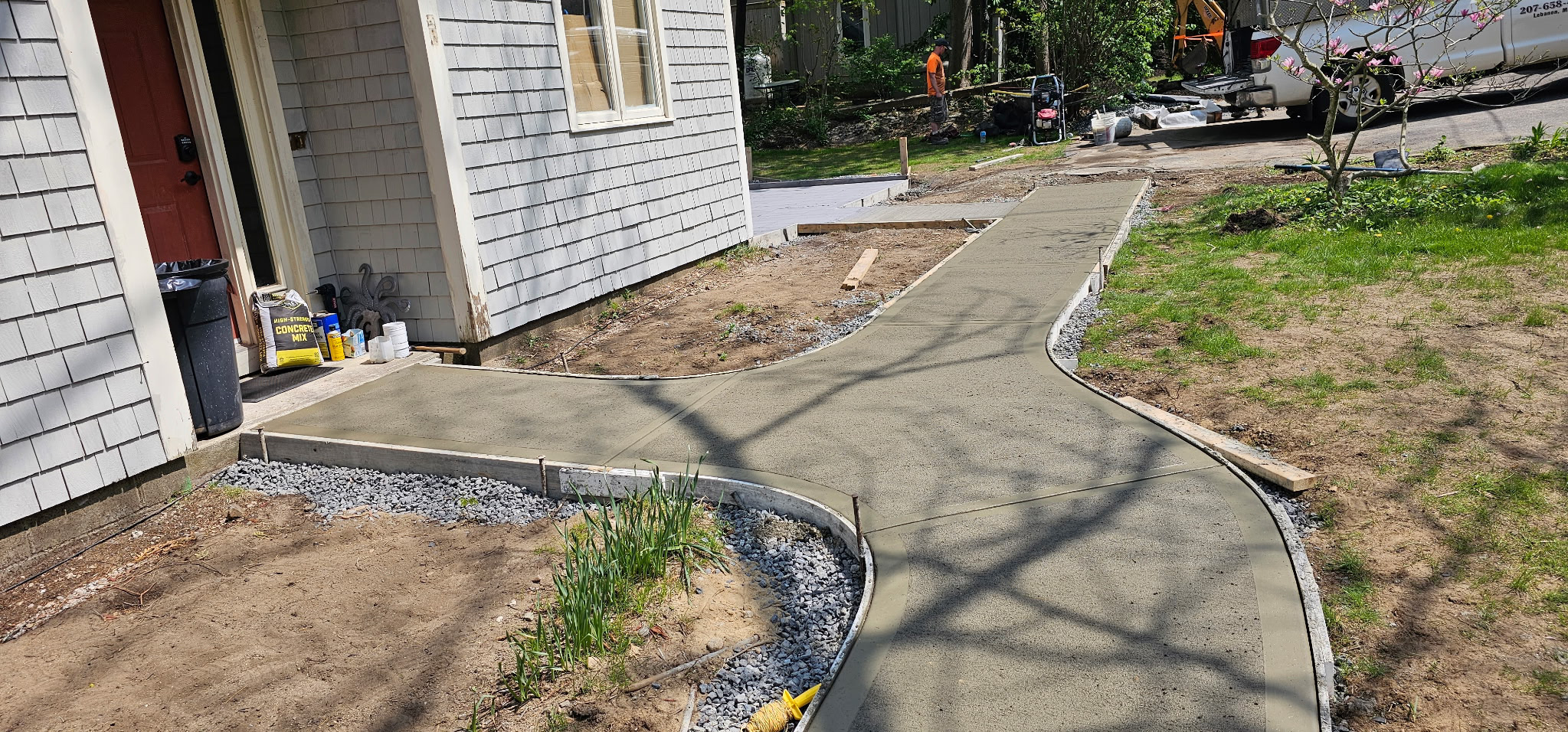 Curved concrete walkway with landscaping — Dover, NH